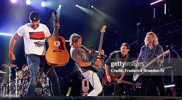 Luke Bryan performs with Keith Urban, guitarist Michael Carter, and bassist James Cook at the CMA Fest at Nissan Stadium on June 12, 2016 in...