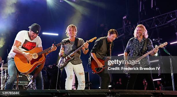 Luke Bryan performs with Keith Urban, guitarist Michael Carter, and bassist James Cook at the CMA Fest at Nissan Stadium on June 12, 2016 in...