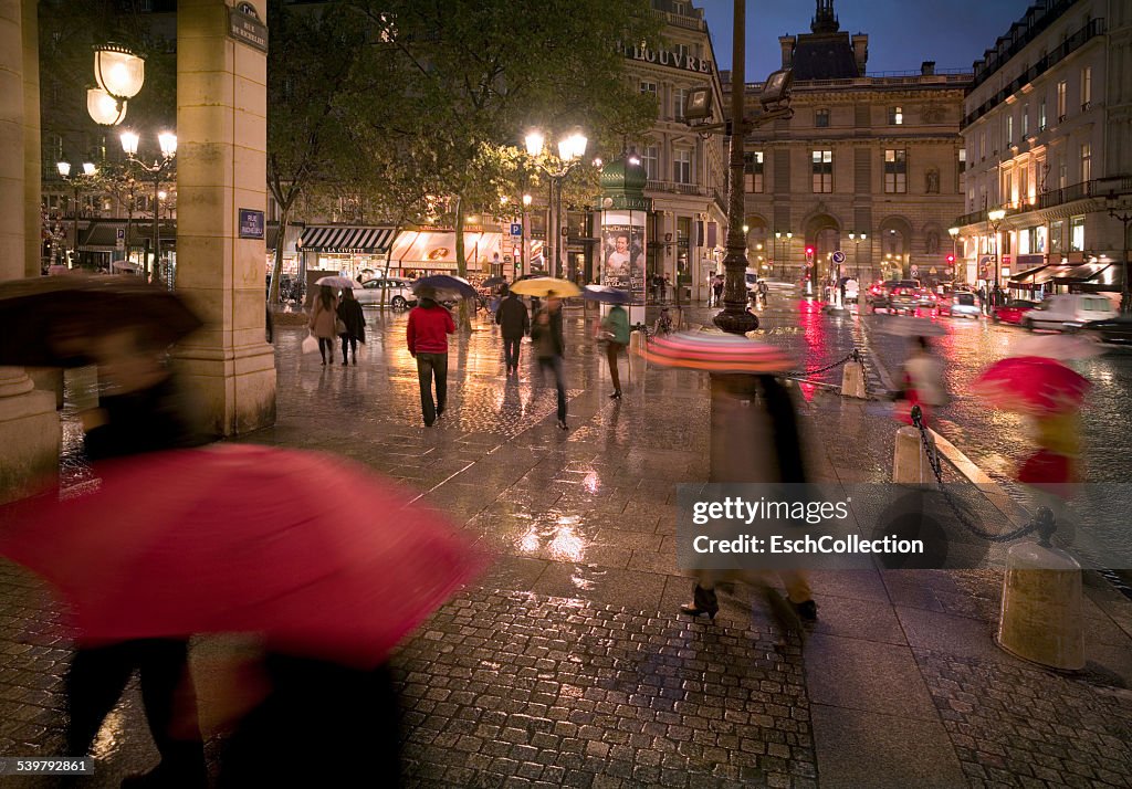 People with umbrellas at center of Paris