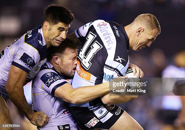 Luke Lewis of the Sharks is tackled during the round 14 NRL match between the Cronulla Sharks and the North Queensland Cowboys at Southern Cross...