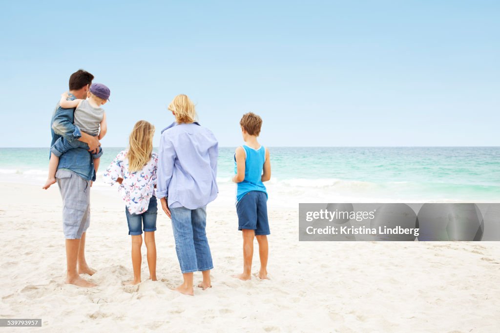 Family of five looking to horizon