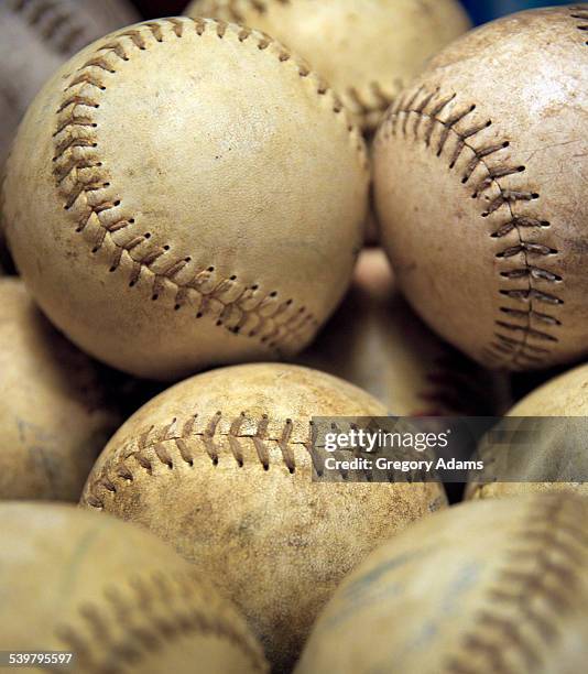 close up of softballs waiting to be used in a game - hatboro stock pictures, royalty-free photos & images