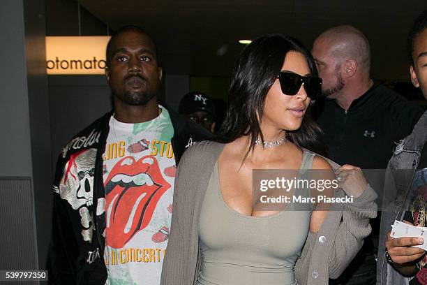 Kanye West and wife Kim Kardashian West arrive at Chrle-de-Gaulle airport on June 13, 2016 in Paris, France.