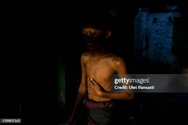 Student walks as he prepares to take a bath at the islamic boarding school Lirboyo during the holy month of Ramadan on June 11, 2016 in Kediri, East...