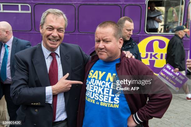 Independence Party leader Nigel Farage jokes with a supporter as he goes on the campaign trail for Brexit in Ramsgate on June 13, 2016. Britain's...