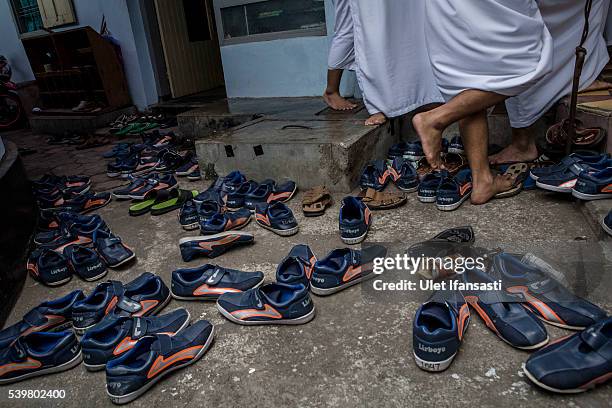 Students shoes are seen as they prepare to perform friday prayers at the islamic boarding school Lirboyo during the holy month of Ramadan on June 10,...