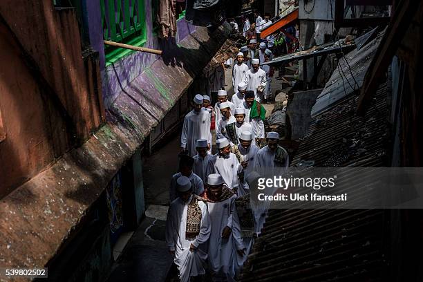 Students walks after friday prayers at the islamic boarding school Lirboyo during the holy month of Ramadan on June 10, 2016 in Kediri, East Java,...
