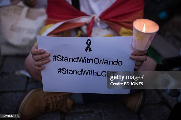 Members of South Korea's LGBT community hold a candle-light vigil for victims of the Orlando shooting, in Seoul on June 13, 2016. US anti-terror...