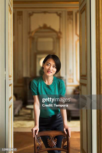 woman standing proudly at her home - paris nice stock pictures, royalty-free photos & images