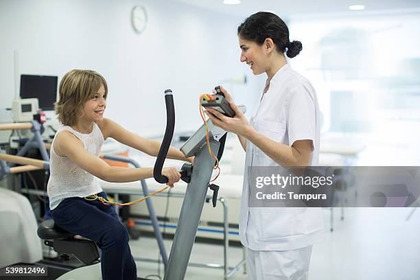 child performing a stress test with electrodes - electrode stock pictures, royalty-free photos & images