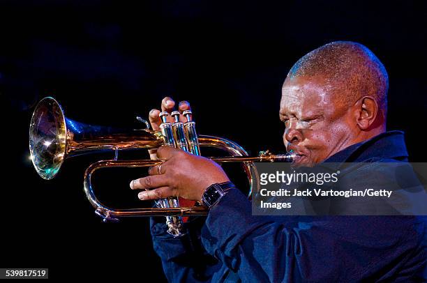South African Jazz musician Hugh Masekela plays flugelhorn during the 'Keep a Light in the Window: An Homage to Joel Dorn' concert at Damrosch Park...