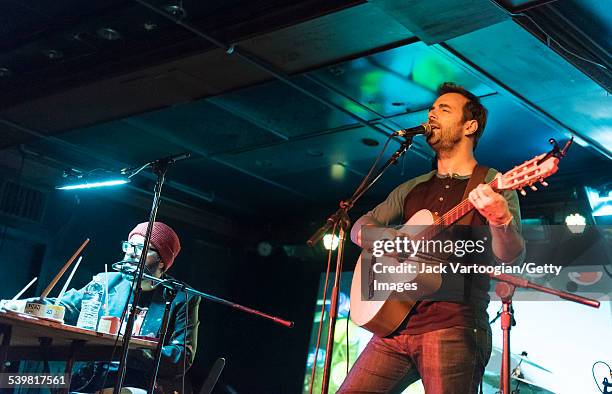 Accompanied on stage by Argentinian cartoonist Liniers , Argentinian-American rock musician Kevin Johansen plays guitar as he performs at the 12th...