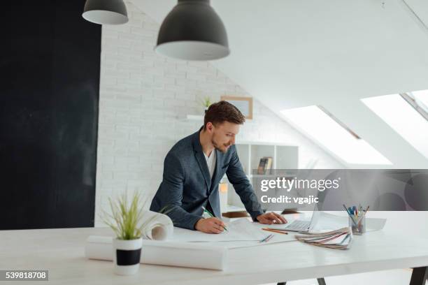 designer working in his new office. - architectural designer stock pictures, royalty-free photos & images