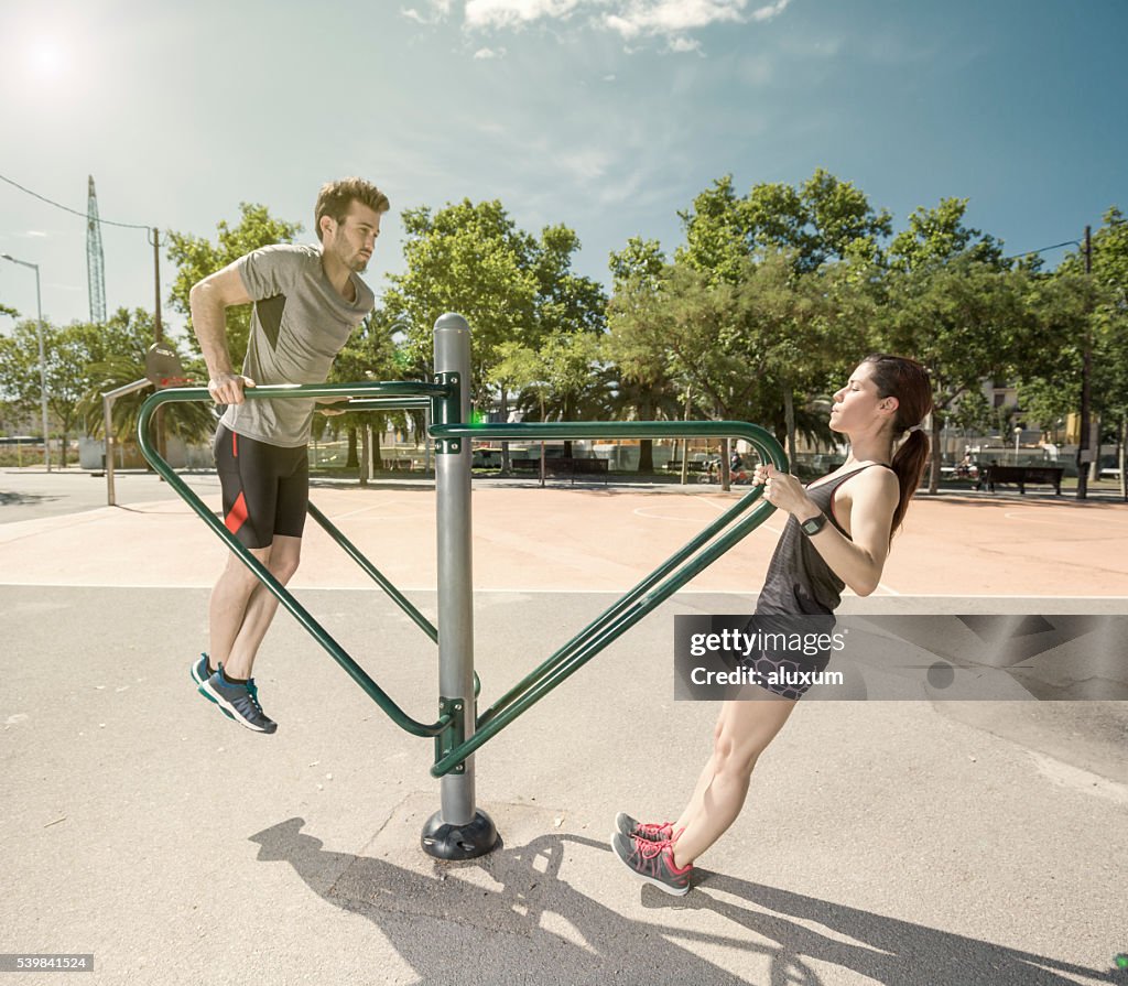 Man and woman doing exercises in the city