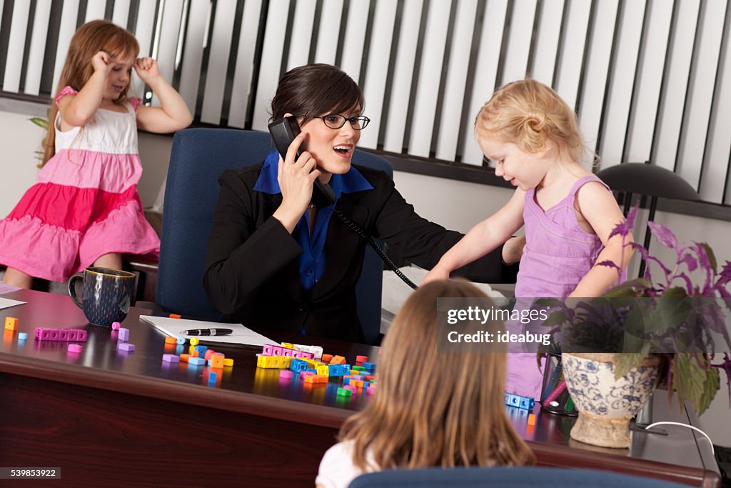 Children Causing Businesswoman Frustration at Work