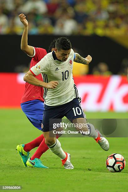 James Rodriguez of Colombia and Yeltsin Tejeda of Costa Rica fight for the ball during a group A match between Colombia and Costa Rica at NRG Stadium...