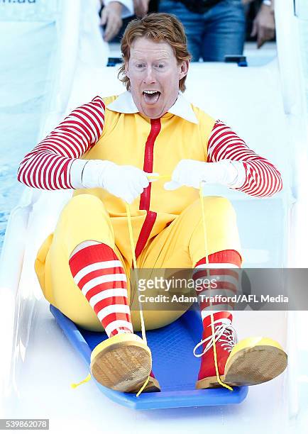 Cameron Ling goes down the Freeze MND slide during the Big Freeze 2 during the 2016 AFL Round 12 match between the Melbourne Demons and the...