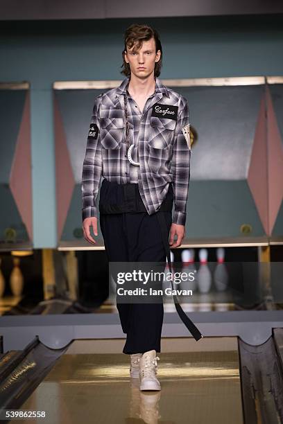 Model walks the runway at the Maison Mihara Yasuhiro show during The London Collections Men SS17 at Bloomsbury Bowling on June 13, 2016 in London,...