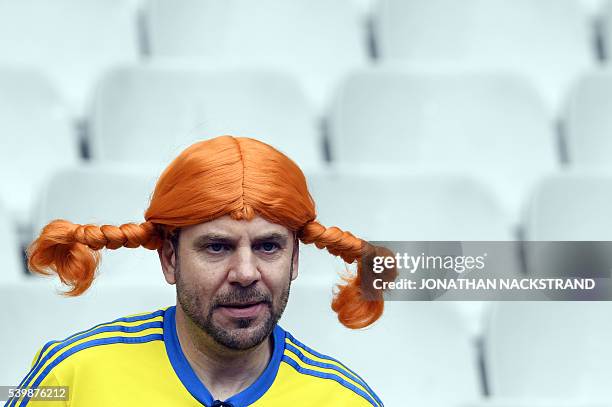 Sweden fan sports a "Pippi Longstocking" wig before the Euro 2016 group E football match between Ireland and Sweden at the Stade de France stadium in...