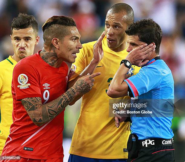 Following the controversial goal that provided the final score of 1-0 in favor of Peru, an official was surrounded by players, form left, Brazil's...