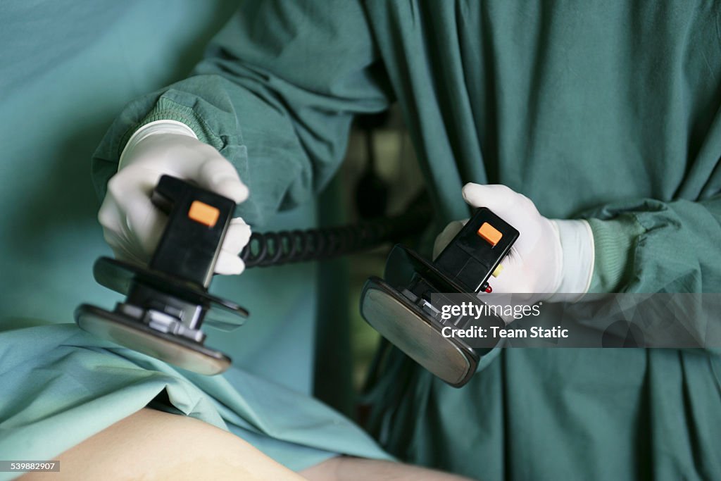 Patient being revived by defibrillator machine
