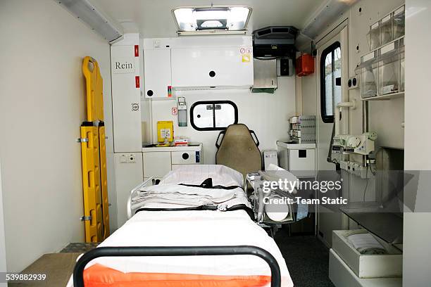 empty stretcher in an ambulance - stretcher stock-fotos und bilder