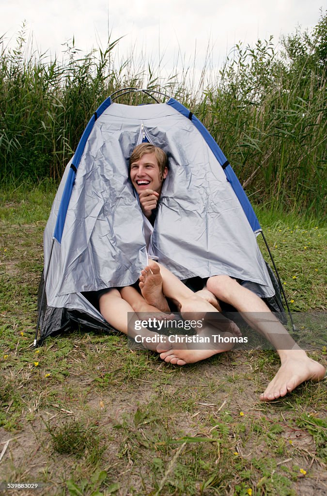 Three people sharing a tent