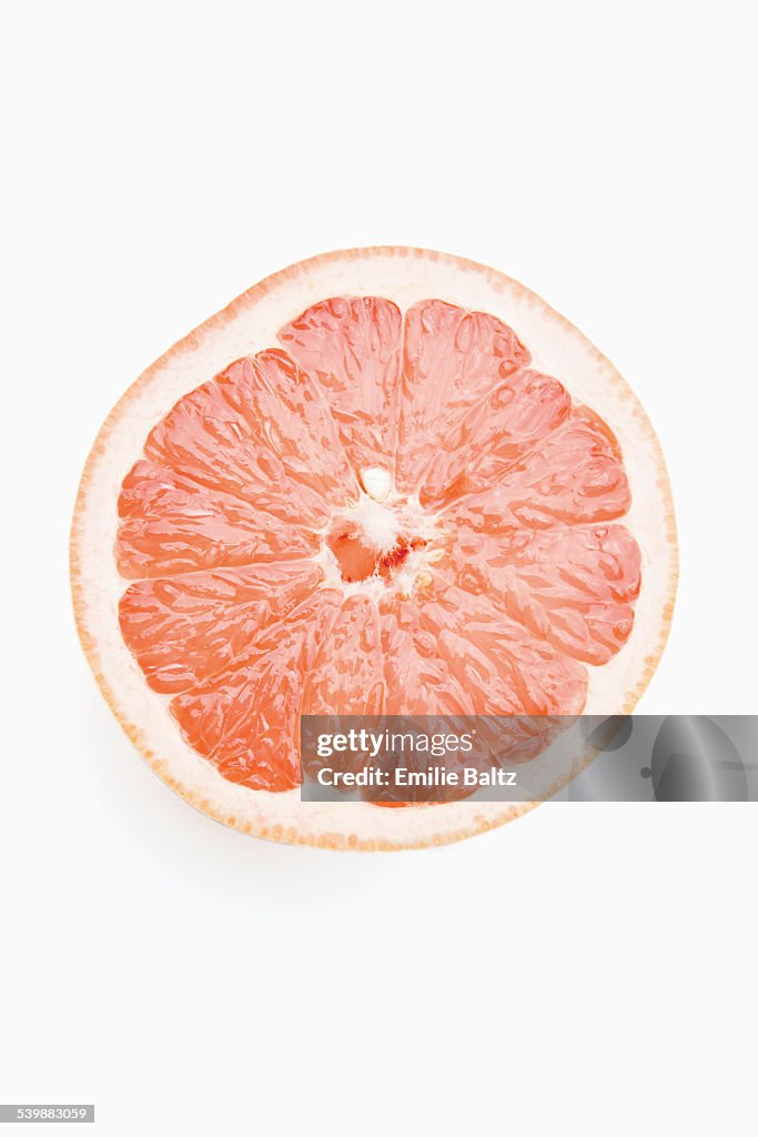 Cross section of grapefruit against white background