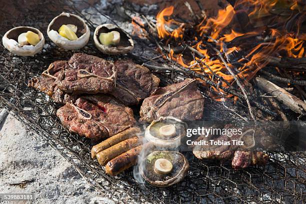 high angle view of meat and mushrooms being grilled - adelaide food stock pictures, royalty-free photos & images