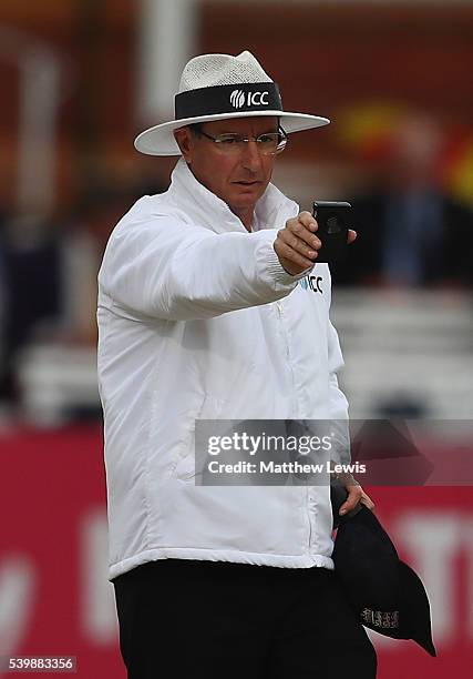 Umpire Rod Tucker holds a light meter during day five of the 3rd Investec Test match between England and Sri Lanka at Lord's Cricket Ground on June...