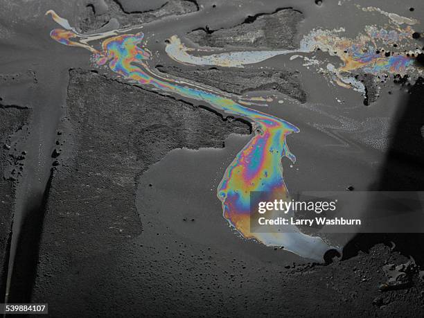 oil patterns on water - oil spill on road stock pictures, royalty-free photos & images