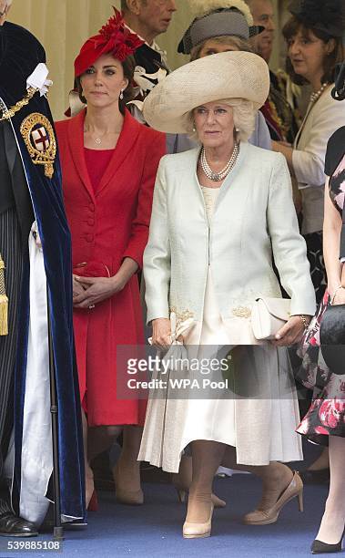 Camilla, Duchess of Cornwall and Catherine, Duchess of Cambridge curtsy as Queen Elizabeth II is driven past them after the Order of The Garter...