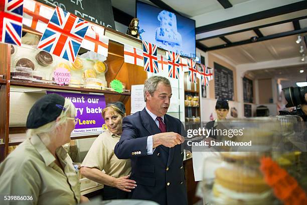 Leader Nigel Farage poses with a cake in Barrow's Bakery on June 13, 2016 in Sittingbourne, England. Mr Farage will be spending the day driving...