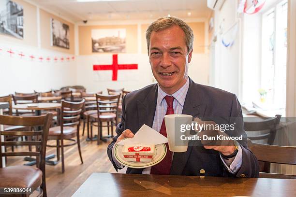 Leader Nigel Farage poses with a cake in Barrow's Bakery on June 13, 2016 in Sittingbourne, England. Mr Farage will be spending the day driving...