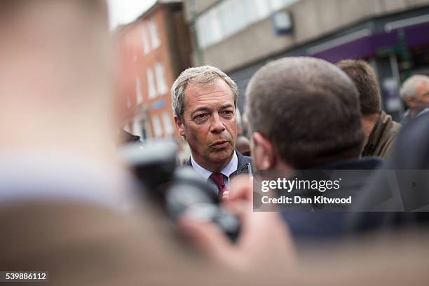 Leader Nigel Farage is left with make-up on his face after being greeted by a supporter during a walk about on June 13, 2016 in Sittingbourne,...