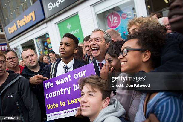 Leader Nigel Farage poses with locals during a walk about on June 13, 2016 in Sittingbourne, England. Mr Farage will be spending the day driving...