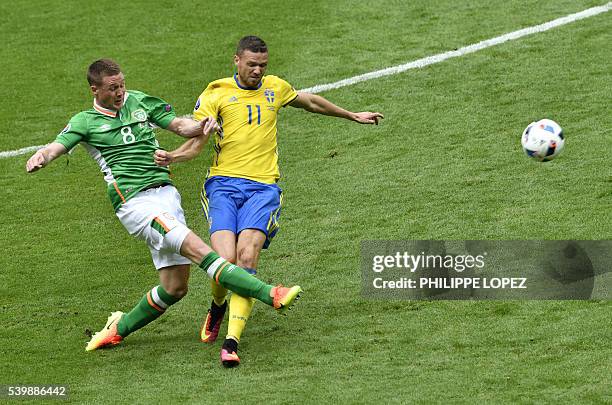 Ireland's midfielder James McCarthy and Sweden's forward Marcus Berg vie for the ball during the Euro 2016 group E football match between Ireland and...