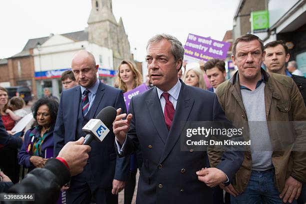 Leader Nigel Faragewalks down the High Street on June 13, 2016 in Sittingbourne, England. Mr Farage will be spending the day driving around the...