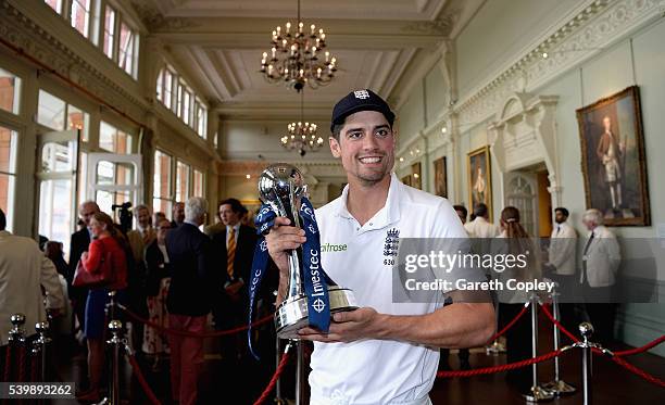 England captain Alastair Cook holds the series trophy in Long Room after winning Investec Test series between England and Sri Lanka at Lord's Cricket...