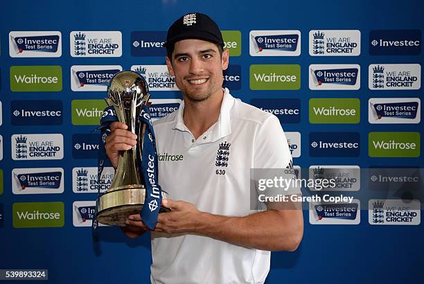 England captain Alastair Cook holds the series trophy in Long Room after winning Investec Test series between England and Sri Lanka at Lord's Cricket...