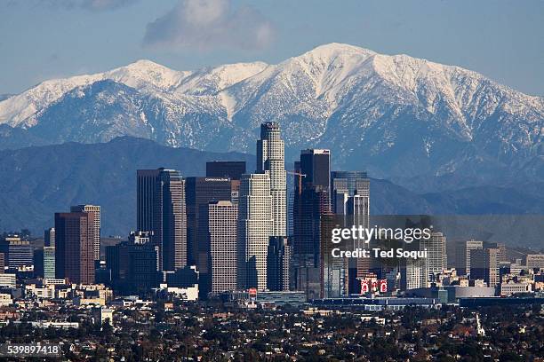 Downtown Los Angeles with a snow capped Mt. Baldy of the San Gabriel Mountain Range in the background.