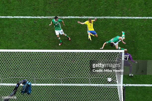 Ciaran Clark of Republic of Ireland heads the ball to score the own goal during the UEFA EURO 2016 Group E match between Republic of Ireland and...