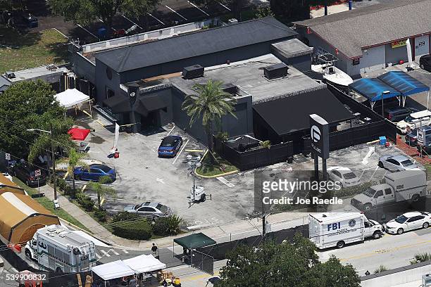Law enforcement officials investigate at the Pulse gay nightclub where Omar Mateen allegedly killed at least 50 people on June 13, 2016 in Orlando,...