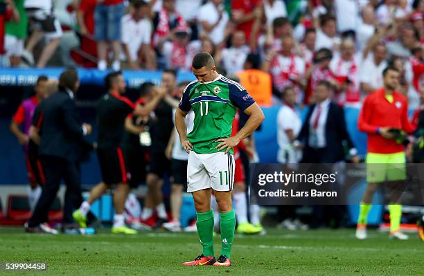 Conor Washington of Northern Ireland show their dejection after his team's 0-1 defeat in the UEFA EURO 2016 Group C match between Poland and Northern...