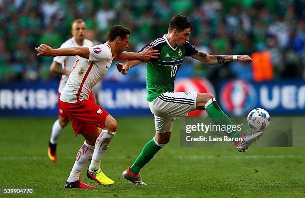 Grzegorz Krychowiak of Poland challenges Kyle Lafferty of Northern Ireland during the UEFA EURO 2016 Group C match between Poland and Northern...