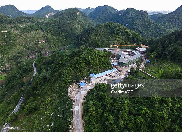 An aerial view of the construction of ancillary facilities around the Five hundred meter Aperture Spherical Telescope on June 10, 2016 in Qiannan...