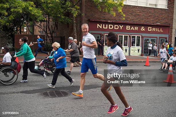 Rep. Sean Patrick Maloney, D-N.Y., runs with his daughter Daley during the "Think Differently Dash" that benefits people with disabilities, in...