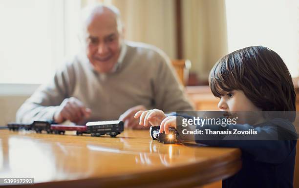 grandfather playing with his grandson - pony play stock-fotos und bilder
