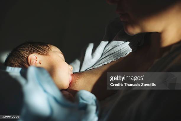 mother with her newborn son - dark baby stock pictures, royalty-free photos & images