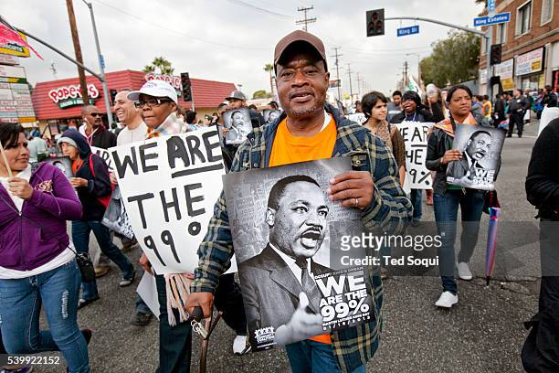 Occupy The Hood marching at the parade. Thousands of people lined the streets of Southwest Los Angeles today for the 27th annual Kingdom Day Parade,...